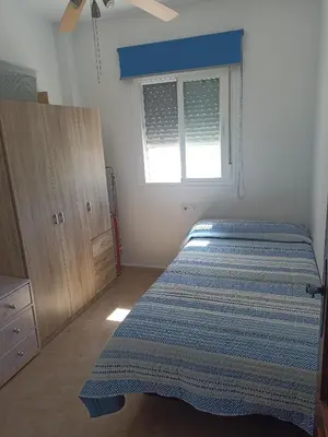 a bedroom with a bed and a window at Argentina in Chiclana de la Frontera