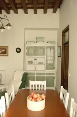a room with a table with a bowl of apples on it at Ático con terraza privada en casa Palacio del Centro Histórico in El Puerto de Santa María