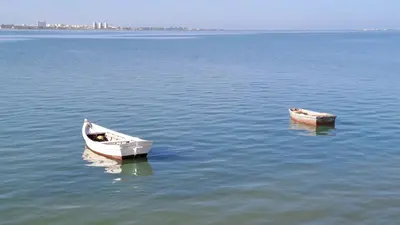 two boats sitting in the middle of the water at Apartamento playa y centro de Puerto Real - AC - WiFi in Puerto Real