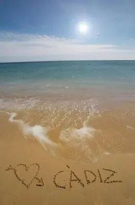 a sign written in the sand on the beach at Apartamento playa y centro de Puerto Real - AC - WiFi in Puerto Real