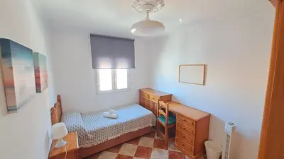 a bedroom with a bed and a dresser and a window at Apartamento playa y centro de Puerto Real - AC - WiFi in Puerto Real