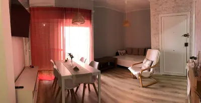 a living room with a table and a bedroom at El sueño de Lola in Chipiona