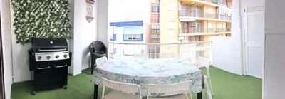 a balcony with a table and a stove and a grill at El sueño de Lola in Chipiona