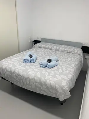 a bed with two blue towels on top of it at Sotavento Alpisteras in Sanlúcar de Barrameda