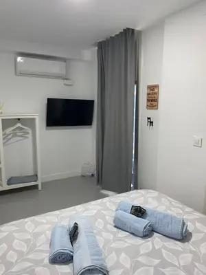 a bedroom with a bed with blue towels on it at Sotavento Alpisteras in Sanlúcar de Barrameda