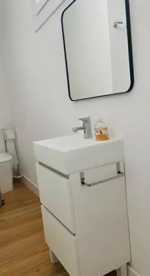 a bathroom with a white sink and a mirror at Sotavento Alpisteras in Sanlúcar de Barrameda