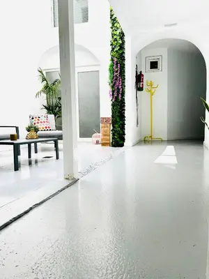 a living room with a white floor and plants at Sotavento Alpisteras in Sanlúcar de Barrameda