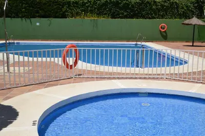 a swimming pool with a fence around it at Apartamento Pie de Rey in Jerez de la Frontera