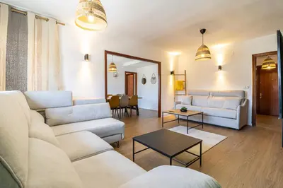a living room with white couches and a table at CR Apartment Jerez in Jerez de la Frontera