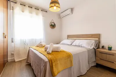 a bedroom with a bed with towels on it at CR Apartment Jerez in Jerez de la Frontera