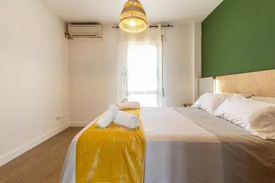 a bedroom with a large bed with towels on it at CR Apartment Jerez in Jerez de la Frontera