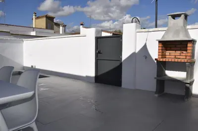 a balcony with a black door on a white wall at Villas Noah in Chiclana de la Frontera