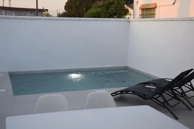 a swimming pool on the roof of a building at Villas Noah in Chiclana de la Frontera