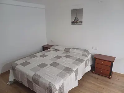 a bedroom with a bed and a nightstand and a bed sidx sidx sidx sidx at Loft Ribera Centro Izquierdo in El Puerto de Santa María