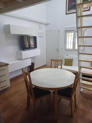 a kitchen and dining room with a table and chairs at Loft Ribera Centro Izquierdo in El Puerto de Santa María