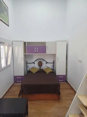 a bedroom with a large bed with purple accents at Loft Ribera Centro Izquierdo in El Puerto de Santa María