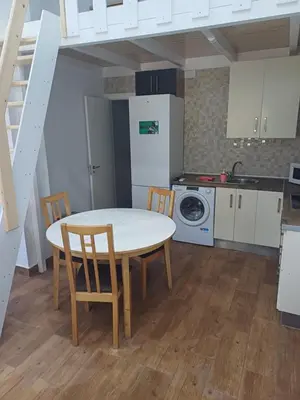 a kitchen with a table and chairs in a room at Loft Ribera Centro Izquierdo in El Puerto de Santa María