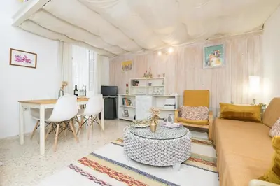 a living room with a couch and a table at El Loft de la Reina - Apartamento Interior in Jerez de la Frontera