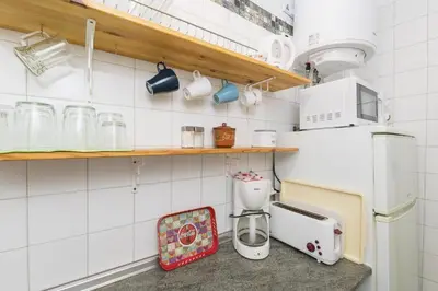 a kitchen with a coffee maker and a refrigerator at El Loft de la Reina - Apartamento Interior in Jerez de la Frontera
