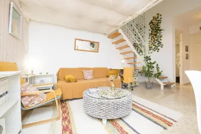 a living room with a couch and a table at El Loft de la Reina - Apartamento Interior in Jerez de la Frontera