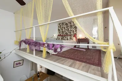 a bedroom with a canopy bed with curtains at El Loft de la Reina - Apartamento Interior in Jerez de la Frontera