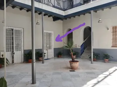 a building with a purple ribbon on the side of it at El Loft de la Reina - Apartamento Interior in Jerez de la Frontera