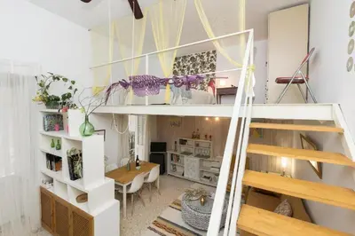 a loft bed with a desk in a room at El Loft de la Reina - Apartamento Interior in Jerez de la Frontera