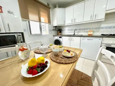 a kitchen with a table with fruit on it at GATU LUCIA 3dormit 2 baños terraza aire acc 