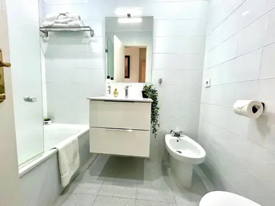 a white bathroom with a sink and a toilet at GATU LUCIA 3dormit 2 baños terraza aire acc 