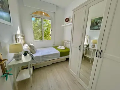 a small bedroom with a bed and a window at GATU LUCIA 3dormit 2 baños terraza aire acc 