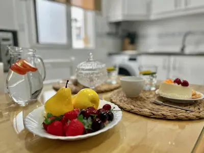 a table with a plate of fruit on a table at GATU LUCIA 3dormit 2 baños terraza aire acc 