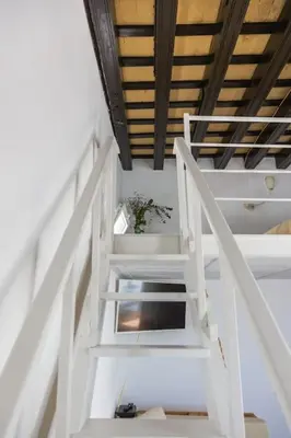 a stairway with a white stair case in a room at Loft/Attic, Sea Views, Private Terrace in Cádiz