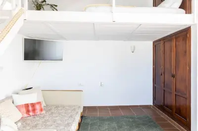 a living room with a couch and a tv at Loft/Attic, Sea Views, Private Terrace in Cádiz