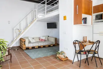 a living room with a couch and a table at Loft/Attic, Sea Views, Private Terrace in Cádiz
