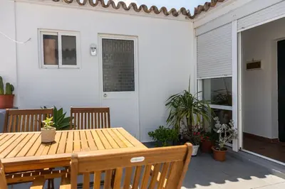 a wooden table and chairs on a patio at Loft/Attic, Sea Views, Private Terrace in Cádiz