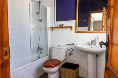 a bathroom with a toilet and a sink and a shower at Loft/Attic, Sea Views, Private Terrace in Cádiz