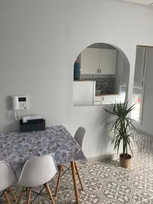 a kitchen and dining room with a table and chairs at Central train station appartament in Jerez de la Frontera