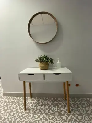 a dressing table with a mirror and a plant on it at Central train station appartament in Jerez de la Frontera