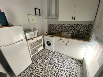 a kitchen with a refrigerator and a washer and dryer at Central train station appartament in Jerez de la Frontera