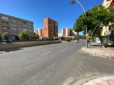 an empty street in a city with tall buildings at Central train station appartament in Jerez de la Frontera
