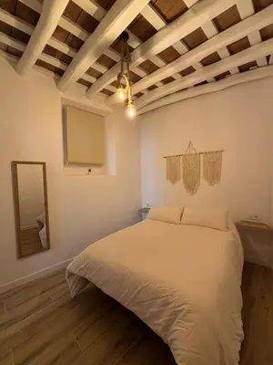 a bedroom with a large bed in a room at Herrete Rooms in Medina Sidonia