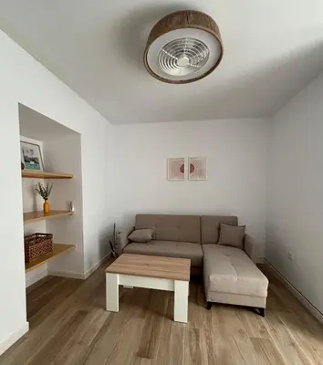 a living room with a couch and a table at Herrete Rooms in Medina Sidonia