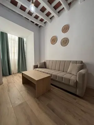 a living room with a couch and a coffee table at Herrete Rooms in Medina Sidonia