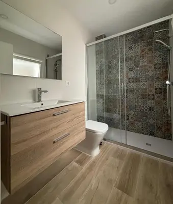 a bathroom with a toilet and a sink and a shower at Herrete Rooms in Medina Sidonia