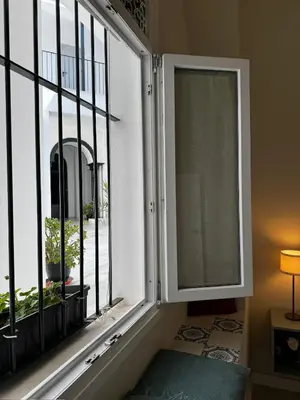 an open window with a view of a courtyard at Karisma Alcázar in Jerez de la Frontera
