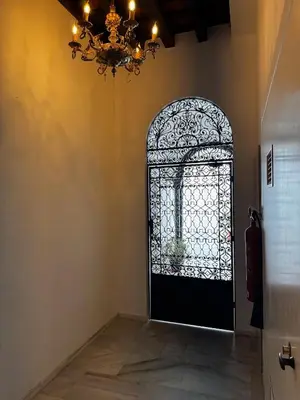 a room with a black door with a chandelier at Karisma Alcázar in Jerez de la Frontera