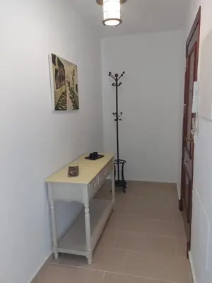 a white desk in a room with a lamp at Apartamento Jardines de la Duquesa con garaje in Sanlúcar de Barrameda