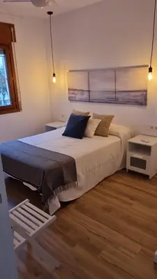 a bedroom with a large bed and a window at Apartamento en Residencial la Caracola en playa la Barrosa in Novo Sancti Petri