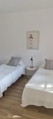 two beds sitting next to each other in a room at Apartamento en Residencial la Caracola en playa la Barrosa in Novo Sancti Petri