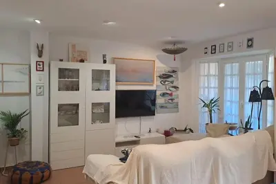 a living room with a tv and a white cabinet at Costa Ballena Casa, pie playa y golf in Costa Ballena